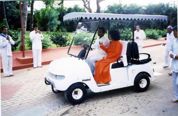 swami in a golf cart darshan