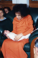 swami holding a baby sri sathya sai baba